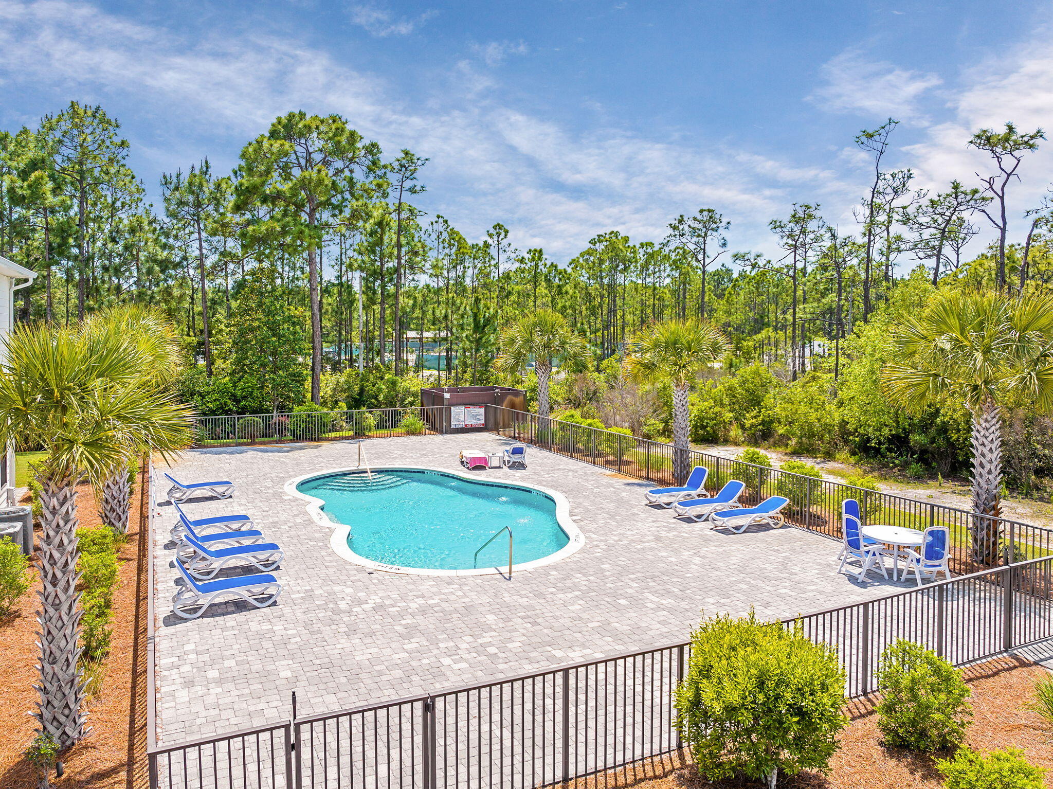 74 Heron's Crossing Santa Rosa Beach, FL 32459 - Photo 26 of 41 a view of a swimming pool with a yard and seating area