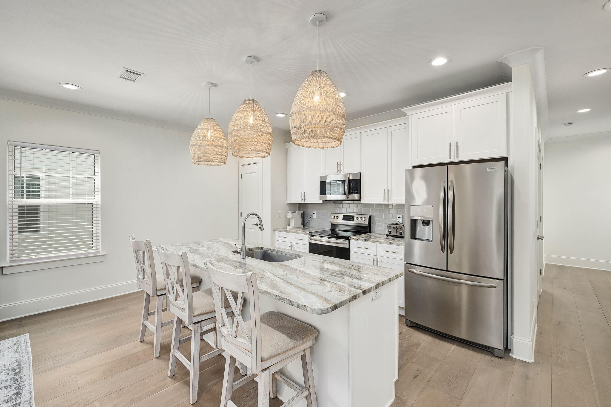 74 Heron's Crossing Santa Rosa Beach, FL 32459 - Photo 7 of 41 a kitchen with granite countertop a table chairs stove and refrigerator
