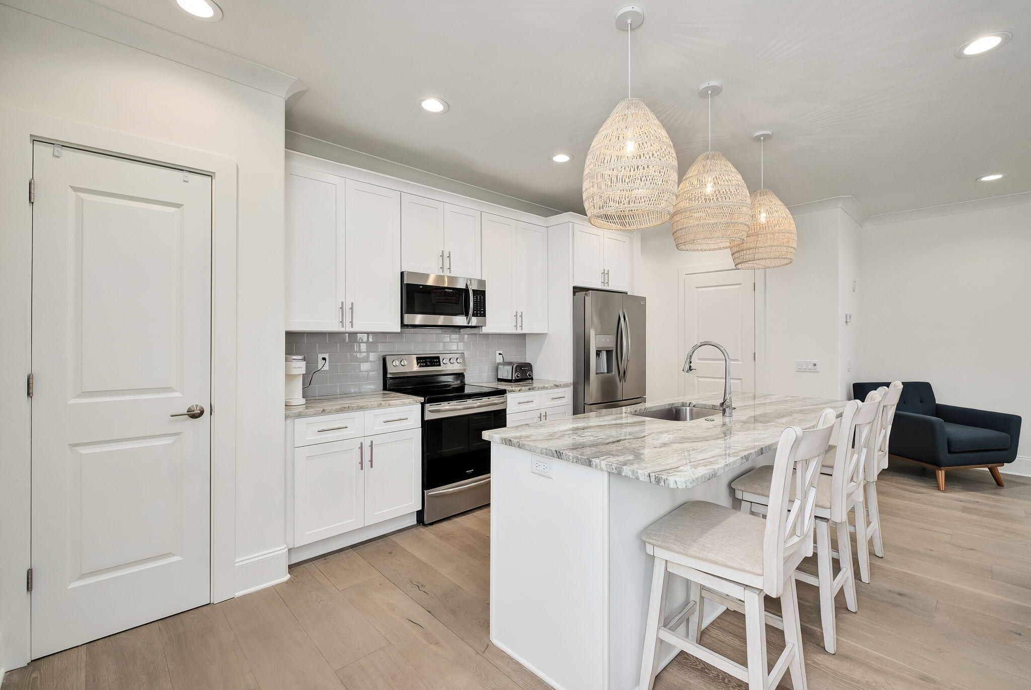 74 Heron's Crossing Santa Rosa Beach, FL 32459 - Photo 8 of 41 a kitchen with stainless steel appliances a table chairs and chandelier