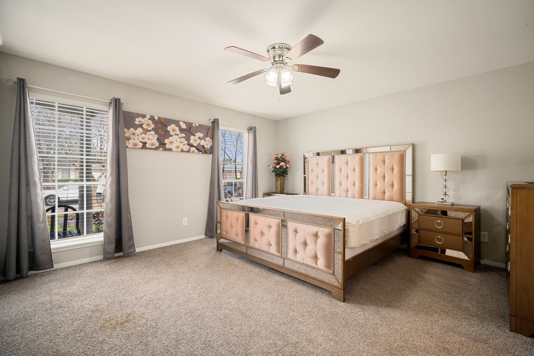 9019 Grape Street Houston, TX 77036 - Photo 11 of 24 a spacious bedroom with a bed and a chandelier