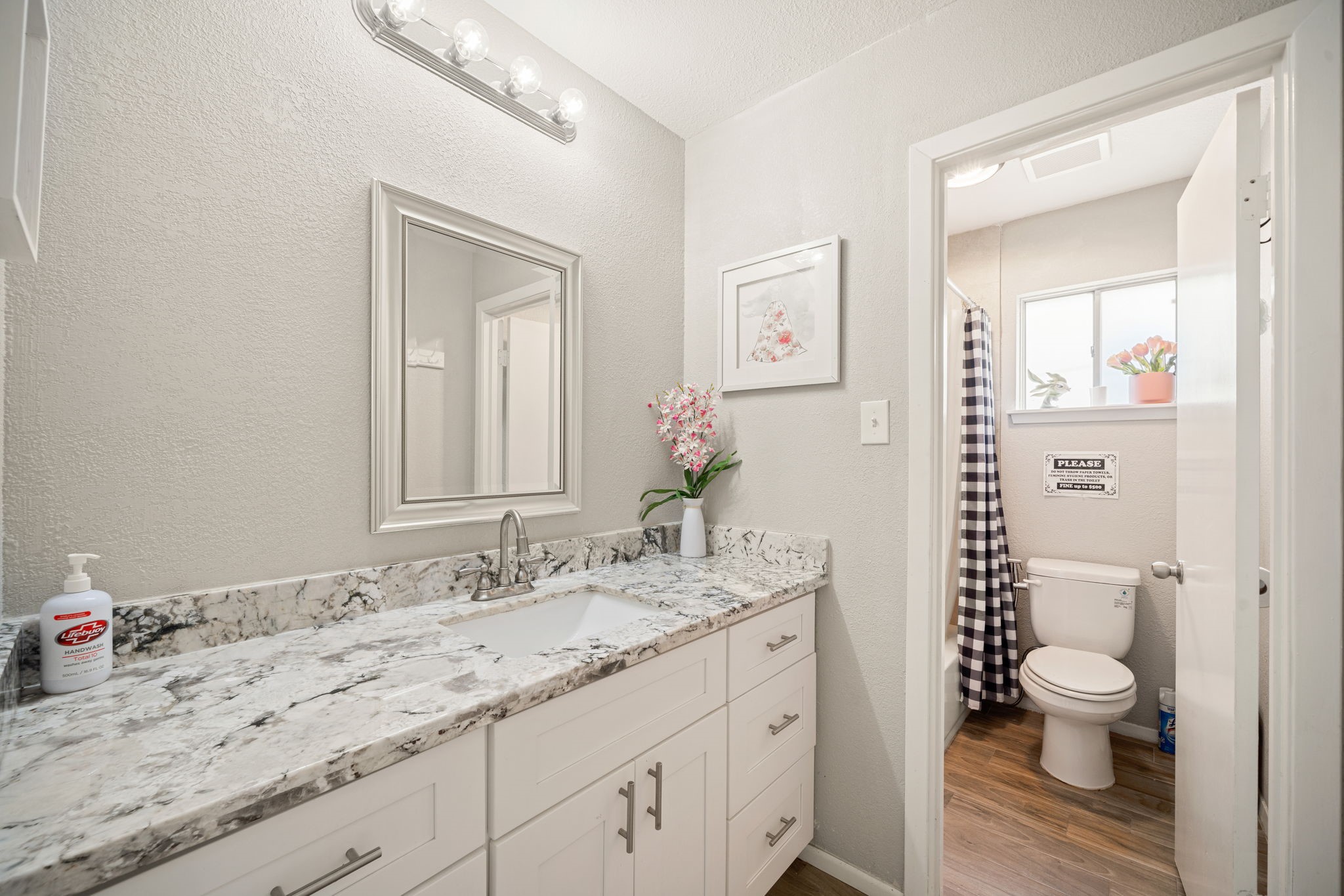 9019 Grape Street Houston, TX 77036 - Photo 12 of 24 a bathroom with a granite countertop sink mirror vanity and toilet