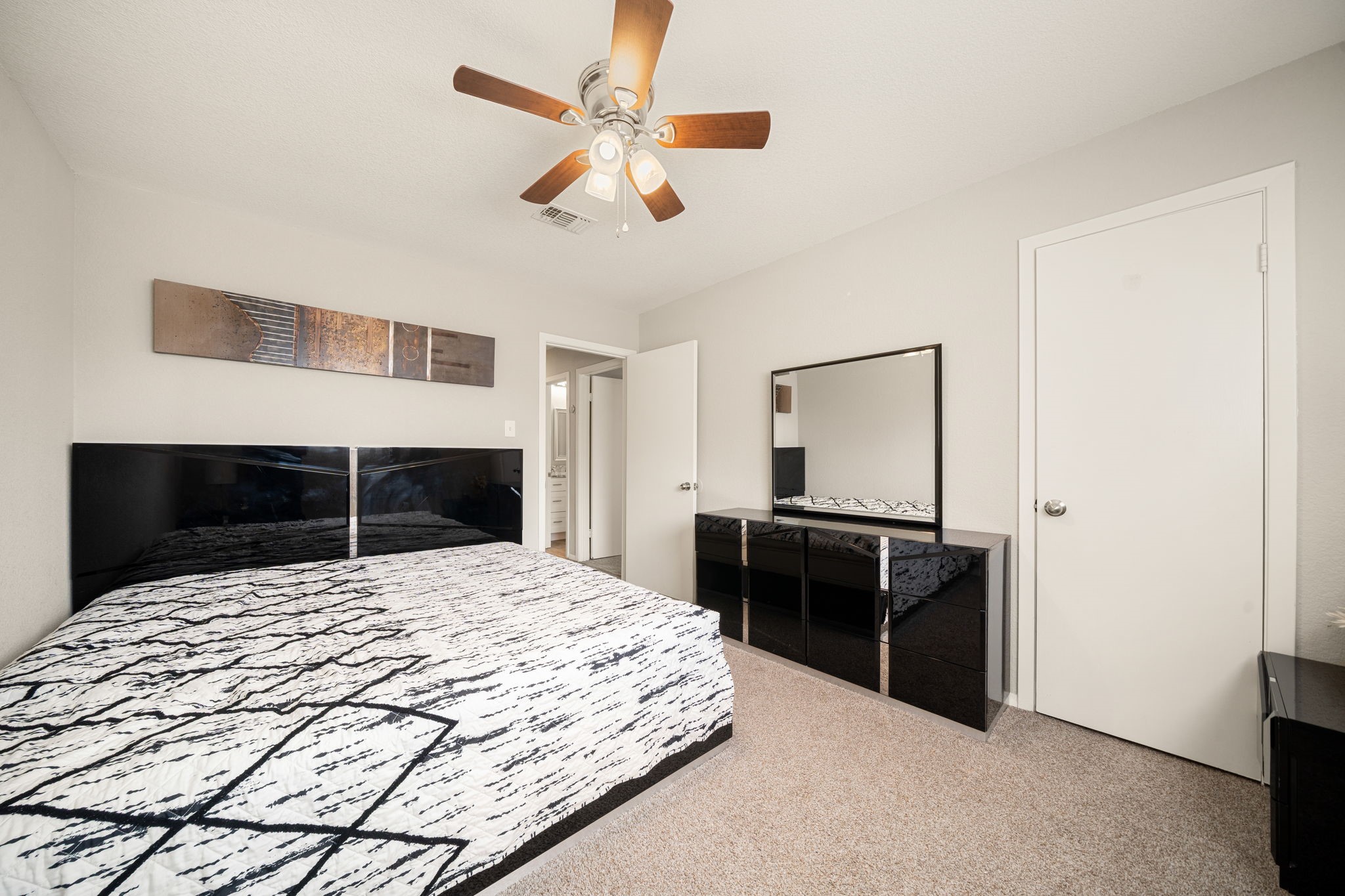 9019 Grape Street Houston, TX 77036 - Photo 15 of 24 a bedroom with a bed and a dresser