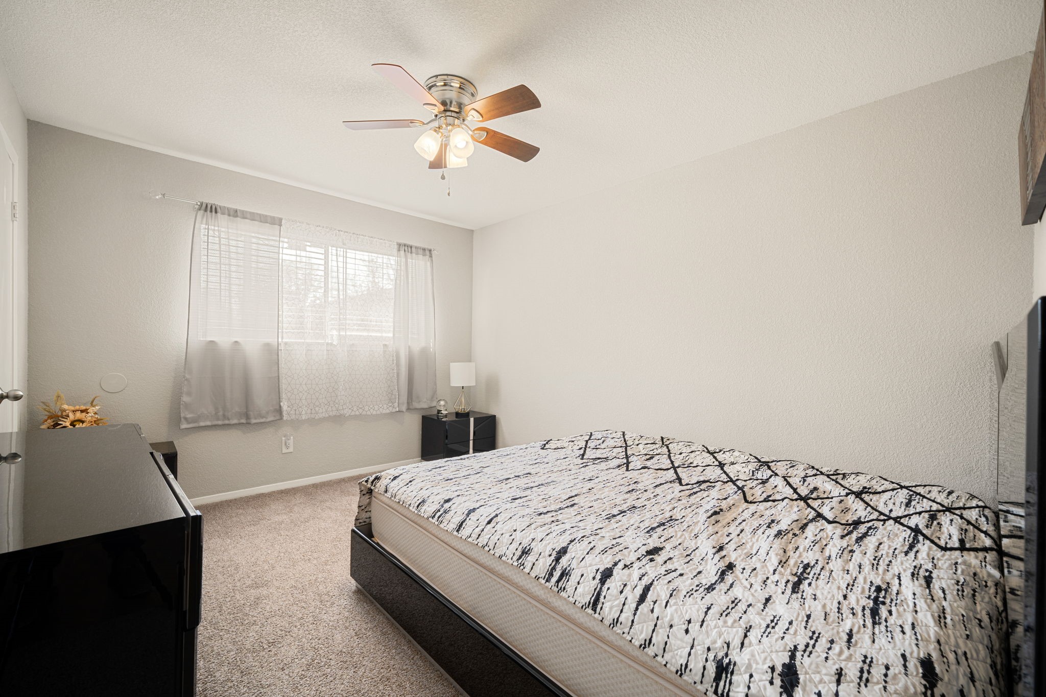9019 Grape Street Houston, TX 77036 - Photo 16 of 24 a spacious bedroom with a bed and a chandelier
