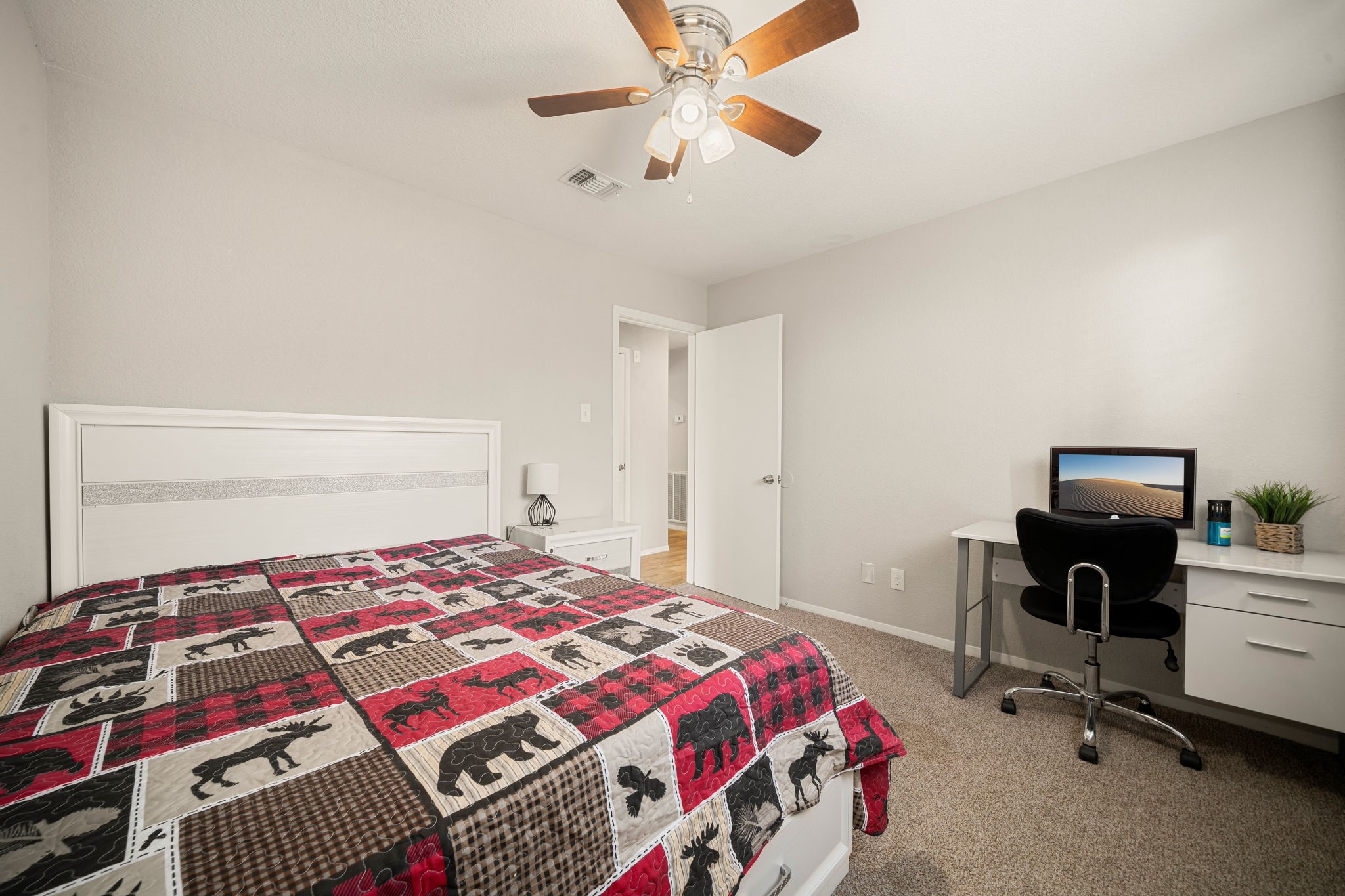 9019 Grape Street Houston, TX 77036 - Photo 17 of 24 a bedroom with a bed and a chandelier