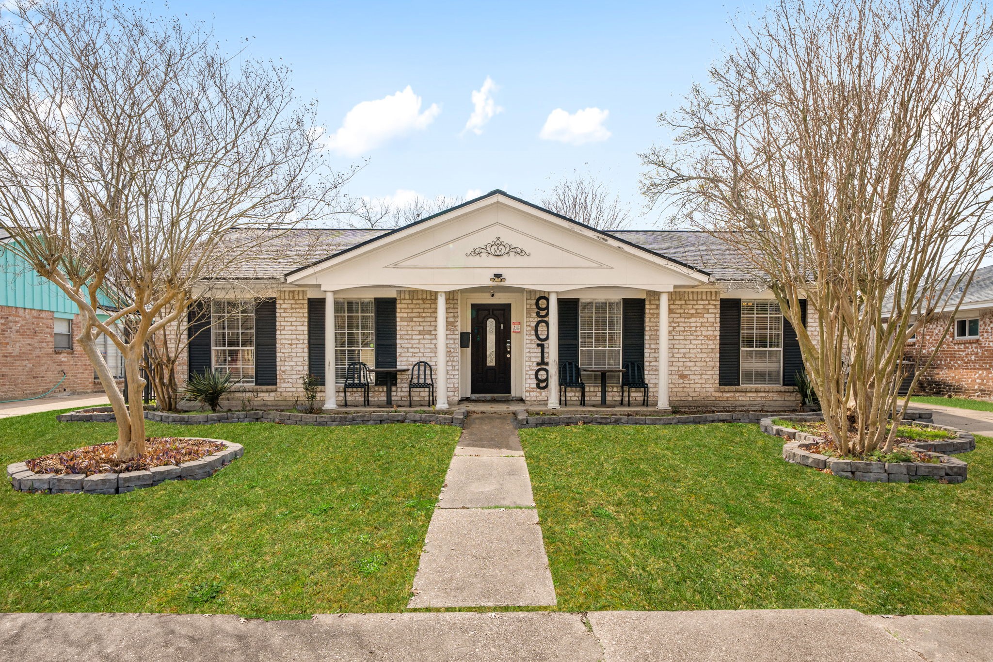 9019 Grape Street Houston, TX 77036 - Photo 2 of 24 a front view of a house with a yard and porch