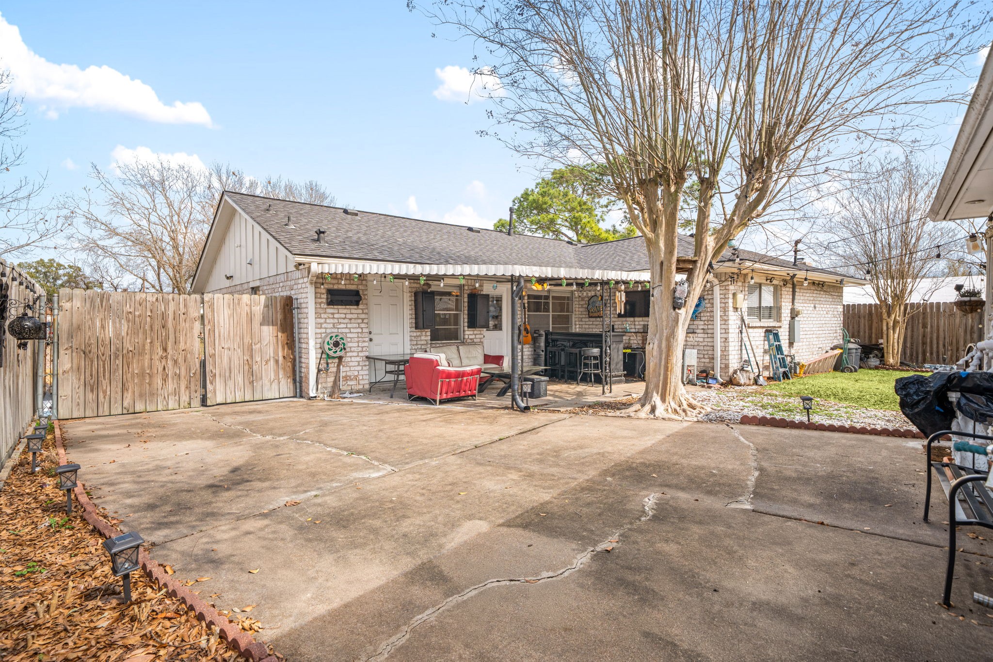 9019 Grape Street Houston, TX 77036 - Photo 22 of 24 a view of a house with a backyard and a tree