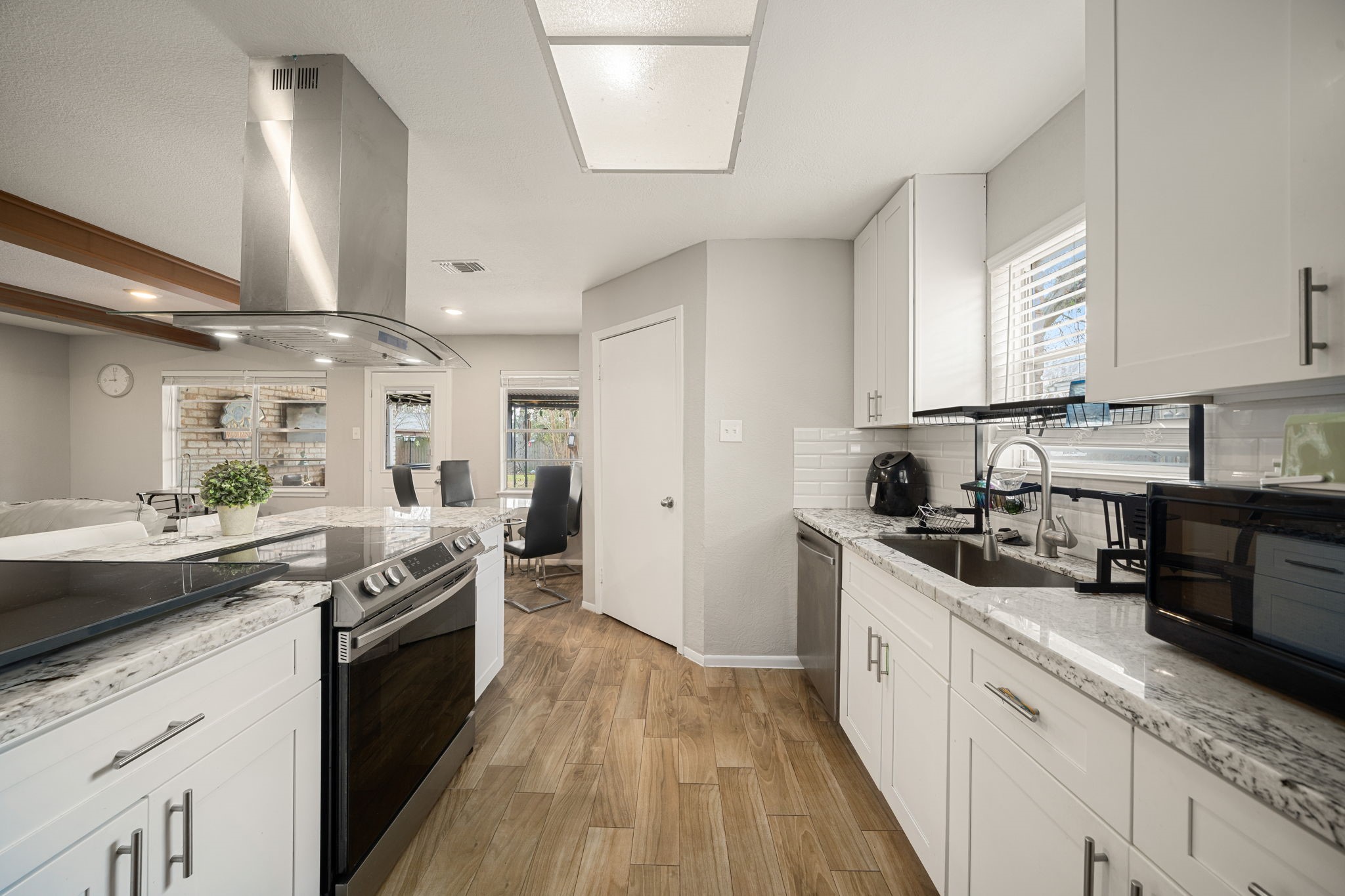 9019 Grape Street Houston, TX 77036 - Photo 8 of 24 a kitchen with stainless steel appliances granite countertop a sink stove and refrigerator