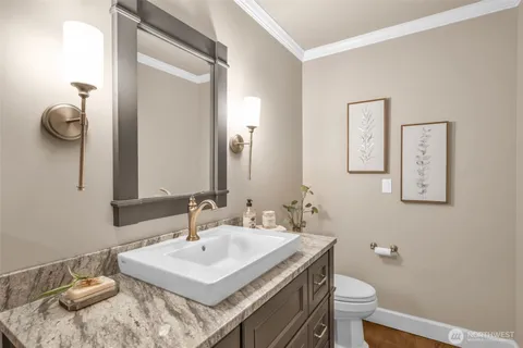 a bathroom with a sink toilet and mirror
