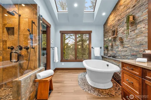 a bath room with a toilet tub and shower