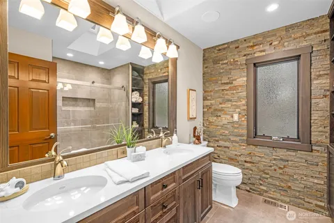 a bathroom with a sink double vanity and a mirror