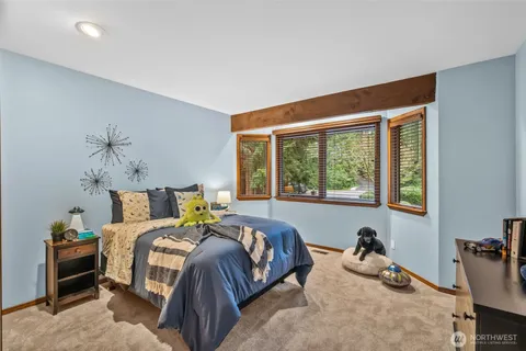 a bed sitting in a bedroom next to a window