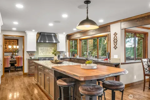 a open kitchen with a dining table and chairs