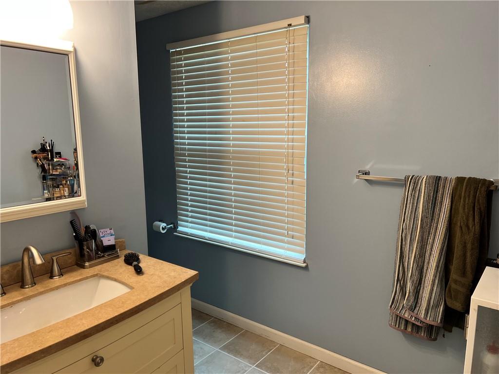 320 Celestial Drive Freedom, PA 15042 - Photo 15 of 25 a bathroom with a sink a mirror and a window