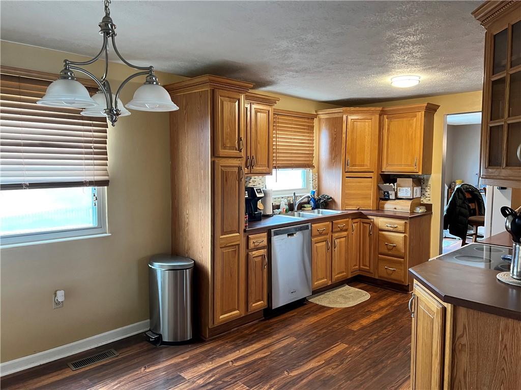 320 Celestial Drive Freedom, PA 15042 - Photo 4 of 25 a kitchen with a refrigerator a sink dishwasher with a dining table and chairs