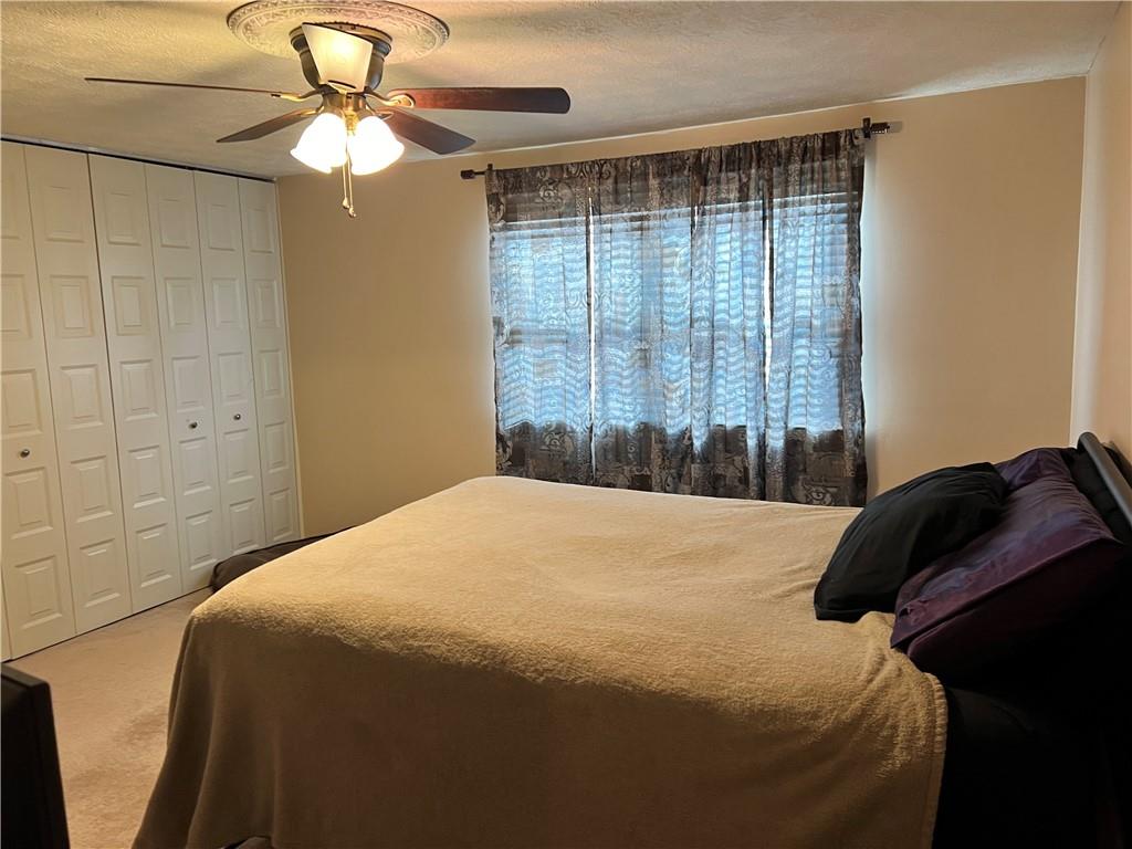 320 Celestial Drive Freedom, PA 15042 - Photo 10 of 25 a bedroom with a bed and a chandelier