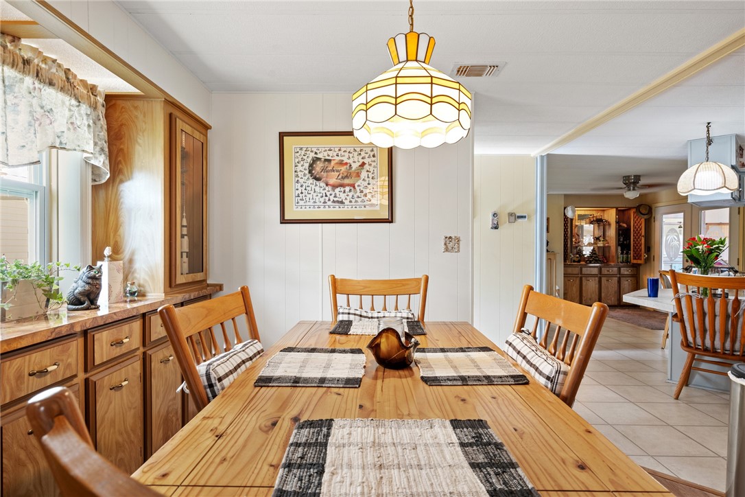 a view of a dining room with furniture a chandelier and wooden floor