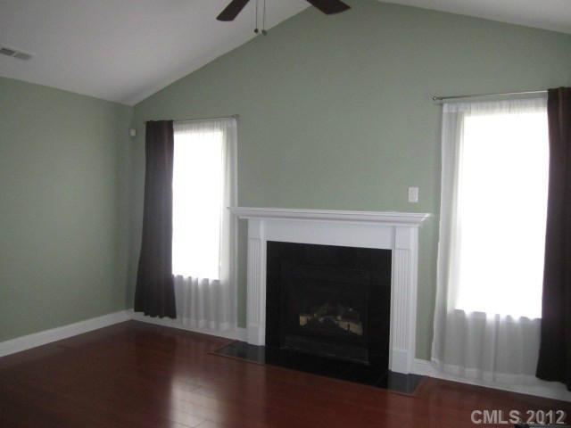 4908 Elizabeth Road Charlotte, NC 28269 - Photo 2 of 16 a living room with a fireplace