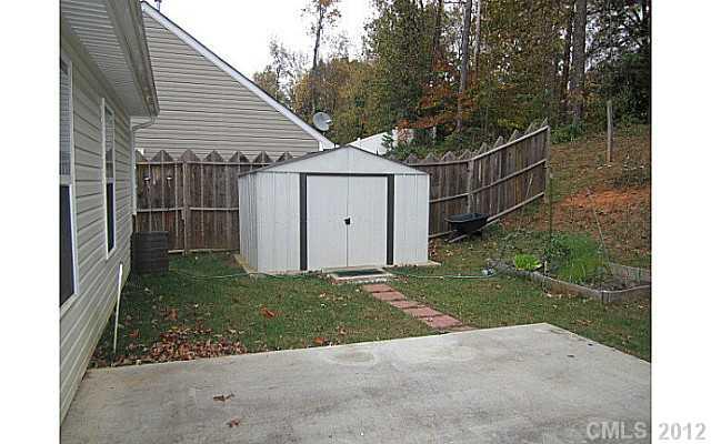 4908 Elizabeth Road Charlotte, NC 28269 - Photo 15 of 16 a view of a garage with a sink and a yard