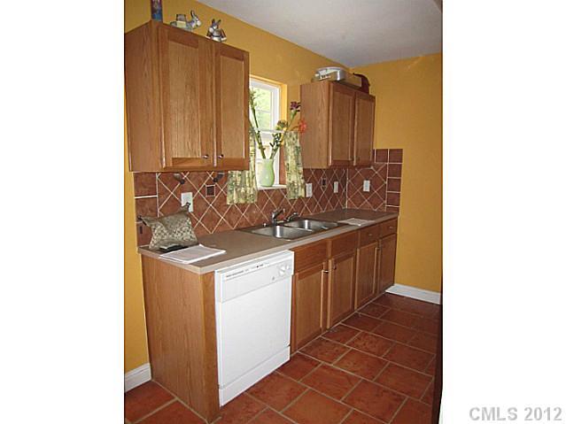 4908 Elizabeth Road Charlotte, NC 28269 - Photo 5 of 16 a kitchen with a sink and cabinets