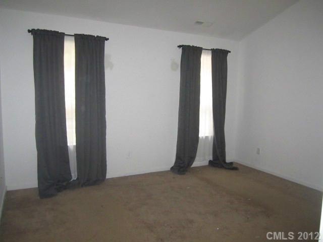 4908 Elizabeth Road Charlotte, NC 28269 - Photo 8 of 16 an empty room with windows