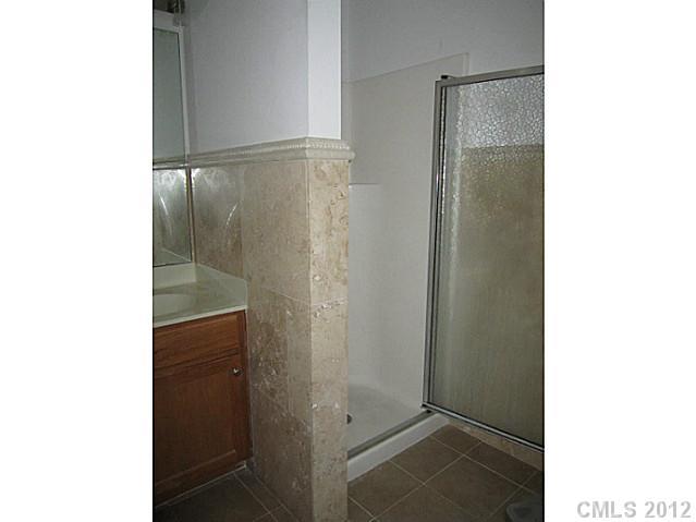 4908 Elizabeth Road Charlotte, NC 28269 - Photo 10 of 16 a bathroom with a shower and a sink