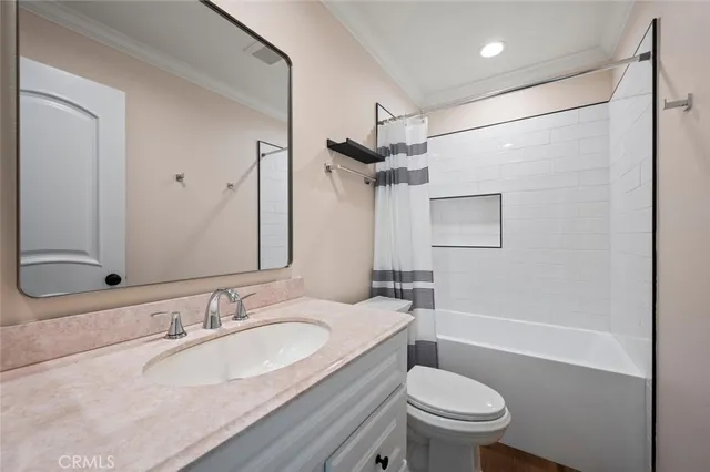 a bathroom with a sink toilet vanity and shower