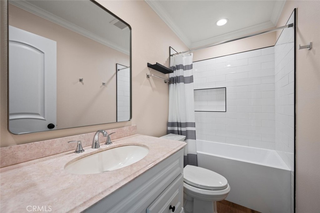 300 Cagney Lane, Unit 102 Newport Beach, CA 92663 - Photo 13 of 28 a bathroom with a sink toilet vanity and shower