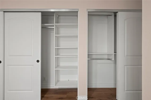 a view of walk in closet with empty racks