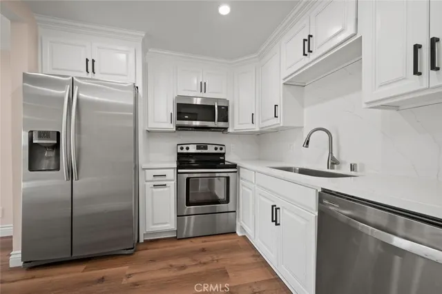 a kitchen with stainless steel appliances a refrigerator stove and sink