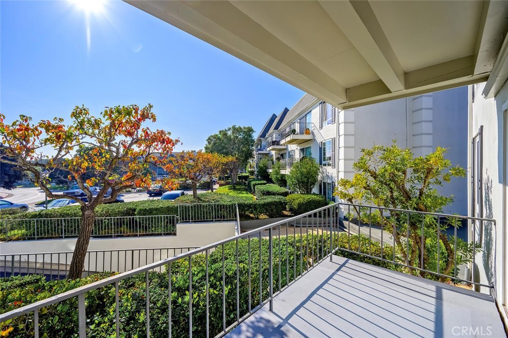 300 Cagney Lane, Unit 102 Newport Beach, CA 92663 - Photo 18 of 28 a view of a garden from a balcony