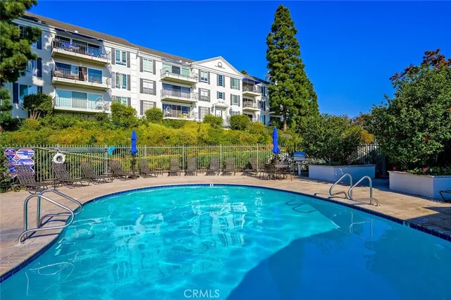 a view of a swimming pool with a lounge chairs