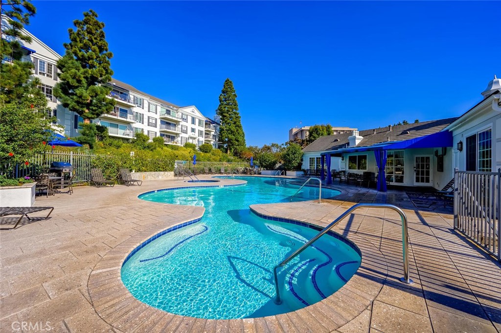 300 Cagney Lane, Unit 102 Newport Beach, CA 92663 - Photo 24 of 28 a view of a swimming pool with a patio