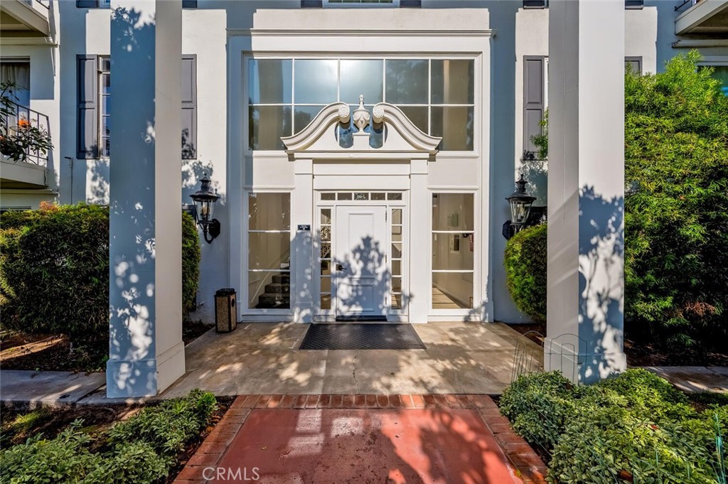 300 Cagney Lane, Unit 102 Newport Beach, CA 92663 - Photo 3 of 28 a front view of a house with a garden
