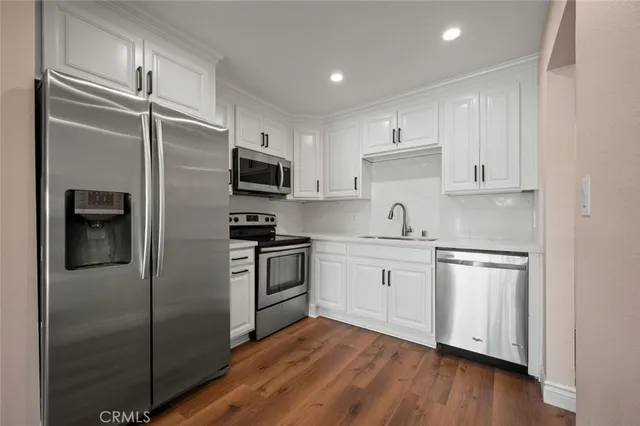 a kitchen with a refrigerator stove and sink