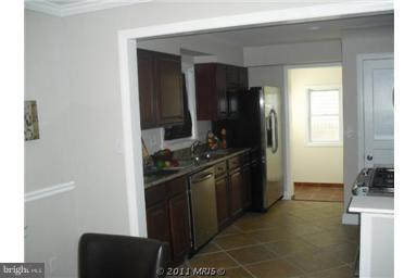 10812 Newport Mill Road Kensington, MD 20895 - Photo 15 of 24 a kitchen with stainless steel appliances granite countertop a refrigerator and a stove