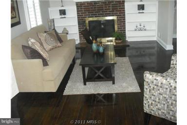 10812 Newport Mill Road Kensington, MD 20895 - Photo 21 of 24 a living room with furniture and a fireplace