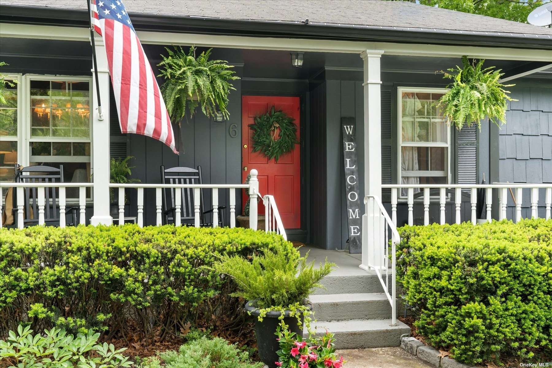 a view of a house with a small yard and plants