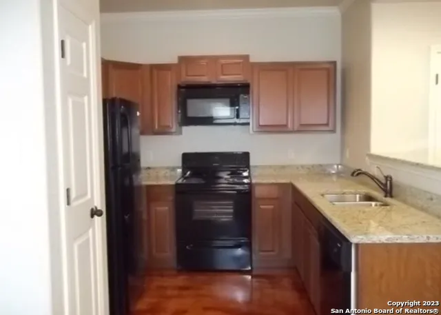 a kitchen with a sink and a refrigerator