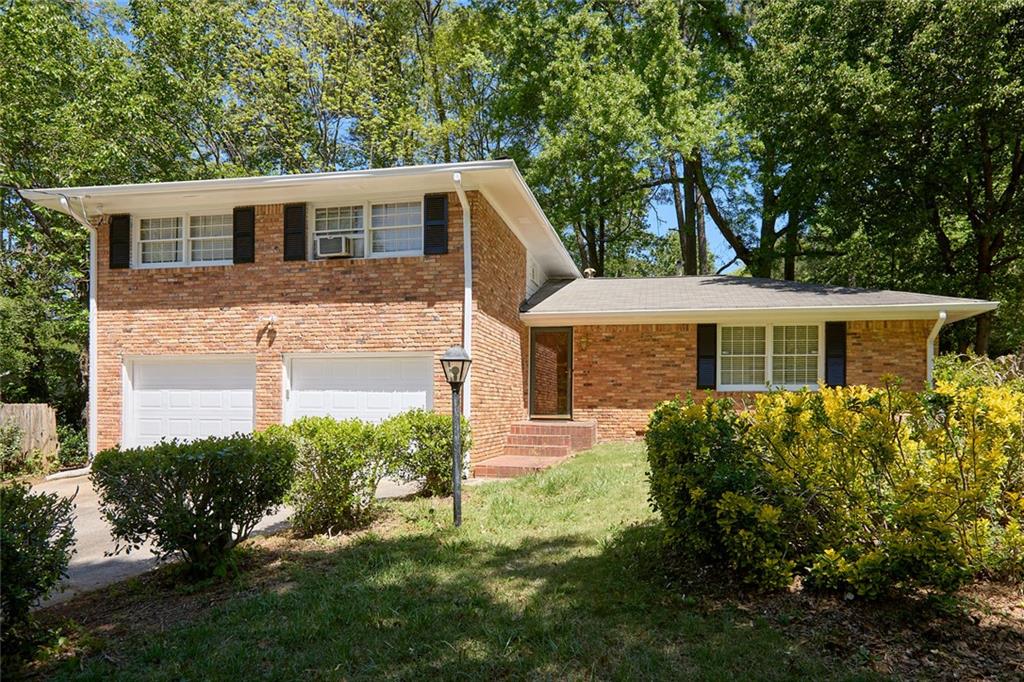 2395 Kelly Lake Drive Decatur, GA 30032 - Photo 1 of 1 a front view of a house with garden