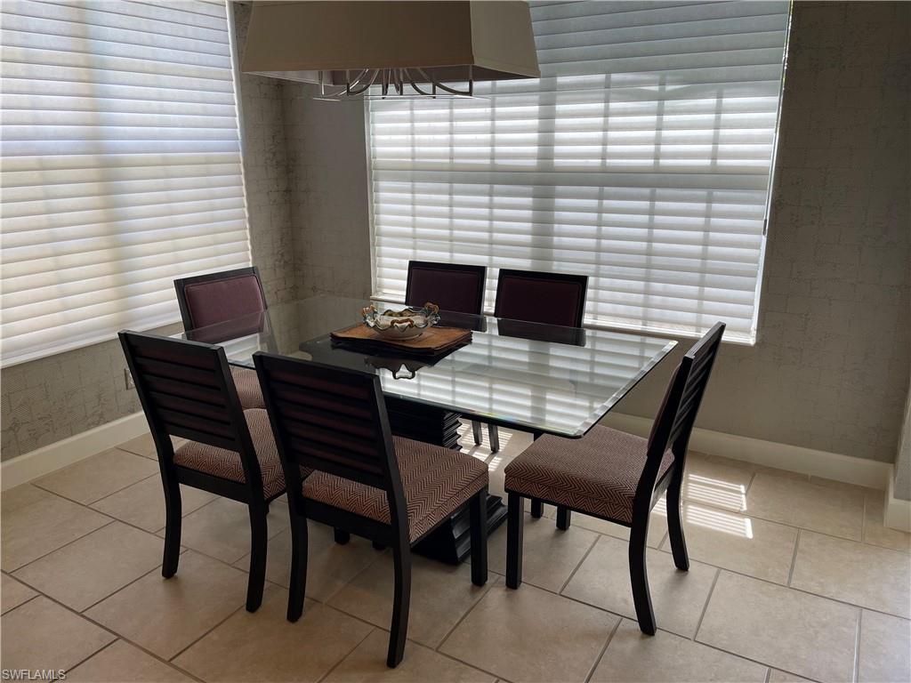 23781 Merano Court, Unit 201 Estero, FL 34134 - Photo 16 of 29 a view of a dining table and chairs in the patio