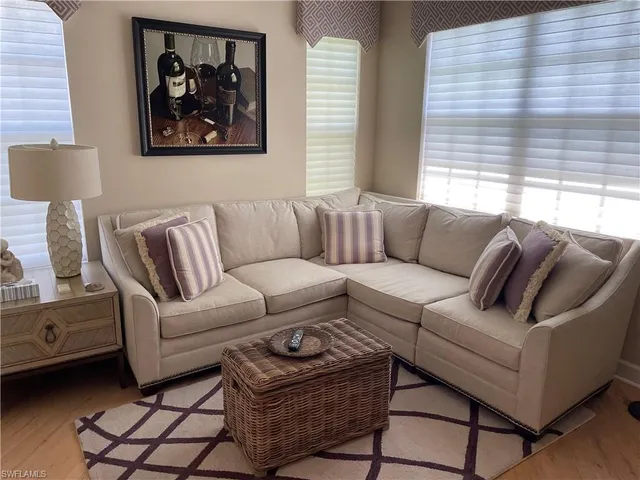 a living room with furniture a couch and a window