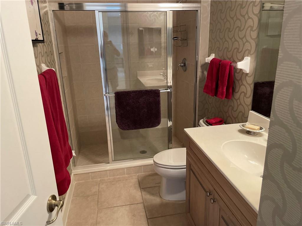 23781 Merano Court, Unit 201 Estero, FL 34134 - Photo 22 of 29 a bathroom with a sink toilet and shower