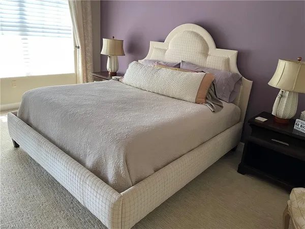 a bedroom with bed and a window