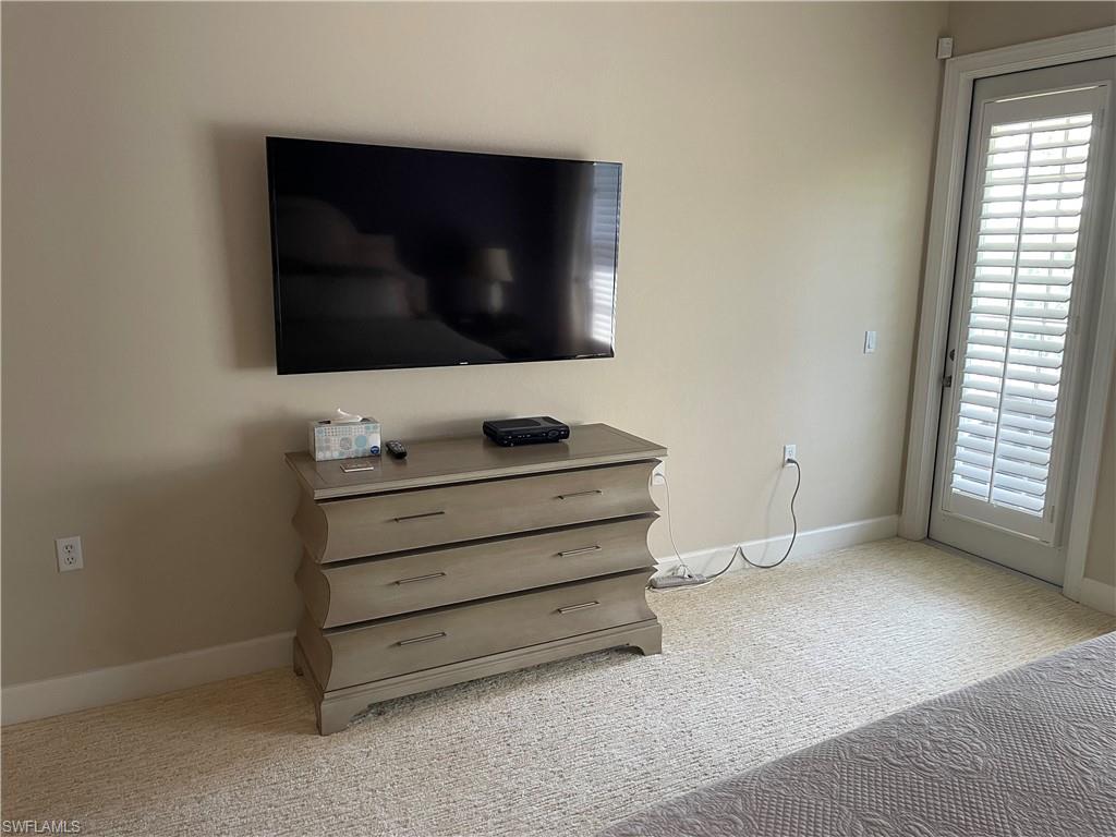 23781 Merano Court, Unit 201 Estero, FL 34134 - Photo 4 of 29 a view of room with window and flat screen tv