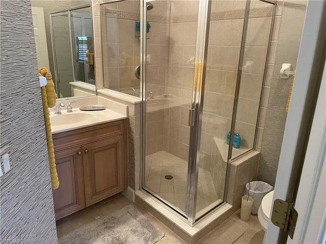 a bathroom with a shower and a sink