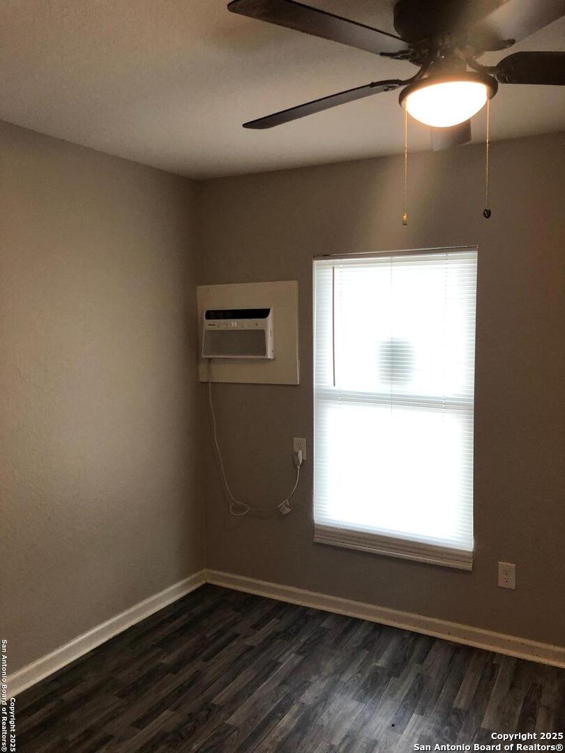211 Robert E Lee, Unit E San Antonio, TX 78214 - Photo 3 of 6 a view of an empty room with wooden floor and a window