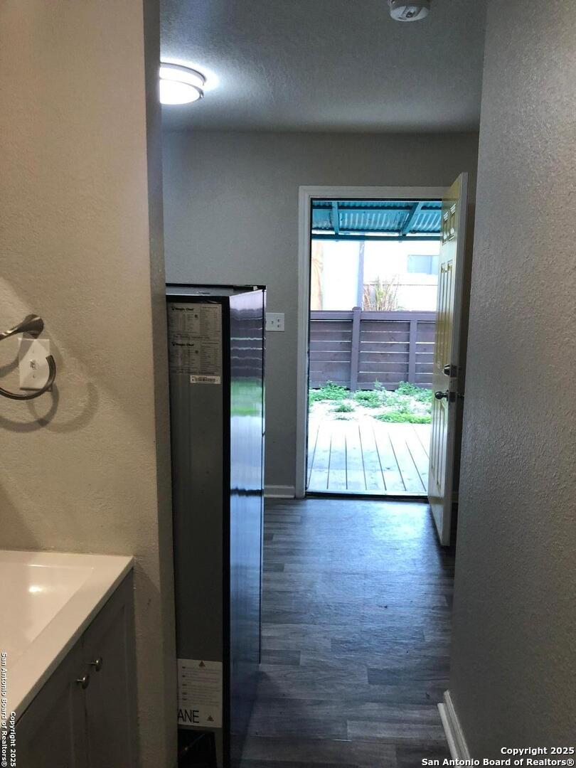 211 Robert E Lee, Unit E San Antonio, TX 78214 - Photo 5 of 6 a view of a hallway with wooden floor and a bathroom