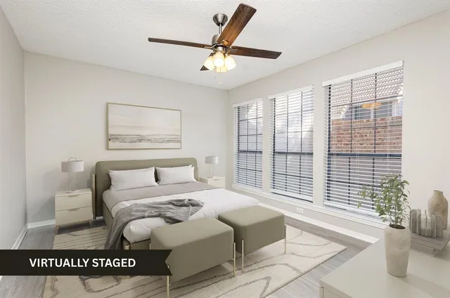 a bedroom with a large bed and a large window