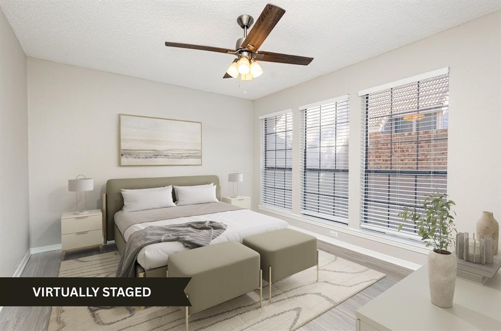 18240 Midway Road, Unit 204 Dallas, TX 75287 - Photo 4 of 21 a bedroom with a large bed and a large window