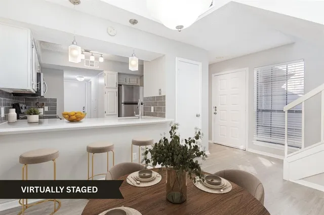 a kitchen with a table and chairs in it